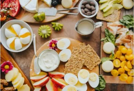 A spread of cheese, fruit, veggies and eggs