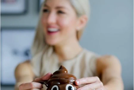 Megan holding a poo shaped mug