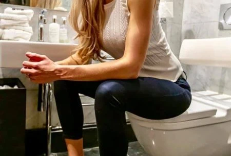Megan Rossi sat on toilet seat