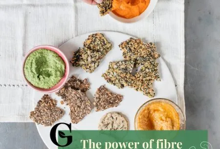 A platter of seeded crackers and small pots of dips