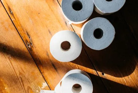 Toilet rolls on a wooden floor