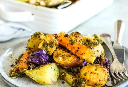 A plate with roasted potatoes, parsnips and walnut pesto