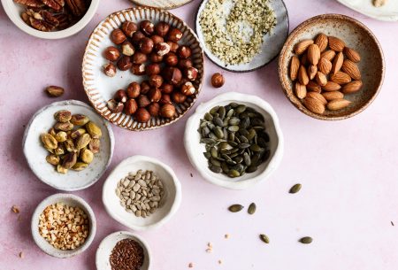 An assortment of small bowls containing nuts and seeds