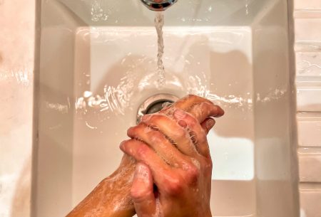 A sink and tap showing washing hands with soap