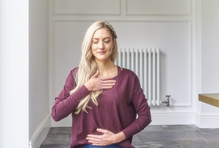 View 5 ways to look after your mental health (& gut health!) Dr Megan Rossi sitting cross-legged on the ground in a mindful yoga pose