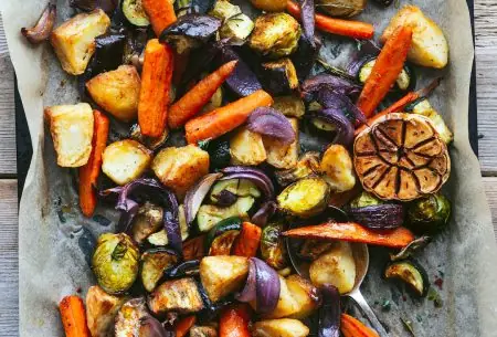 A tray with a baking sheet of roasted vegetables