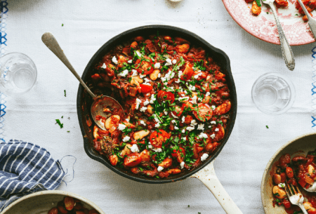 Gut-friendly Greek baked beans in a pan on a white table