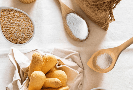 View The GAPS diet: filling in the gaps! Bench top with mixed grains such as rice, bread etc displayed in an assortment of wooden bowls and spoons