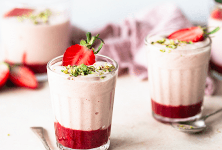 Three pots prebiotic strawberry mousse, topped with fresh strawberries