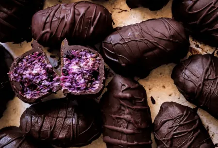 Photo of bitesize bounty bars that also include blueberries and beetroot, on a kitchen counter top