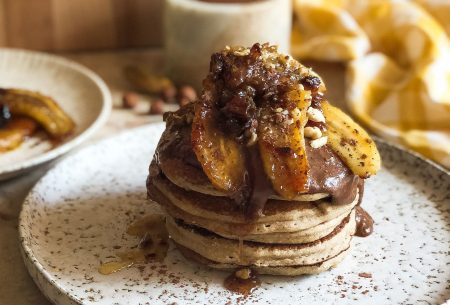 A stack of pancakes with homemade nutella and caramelised bananas on top