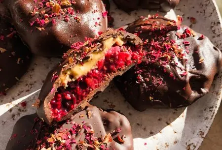 An image of the berry jam & nut butter chocolate bites on a plate