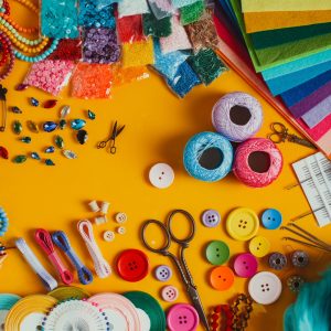 A photo of craft materials on a yellow table