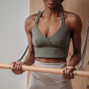 A photo of a woman holding a ballet bar, working out