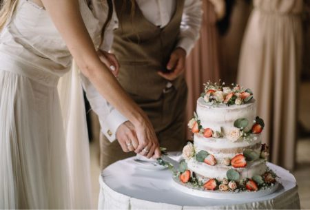A couple cutting a wedding cake together
