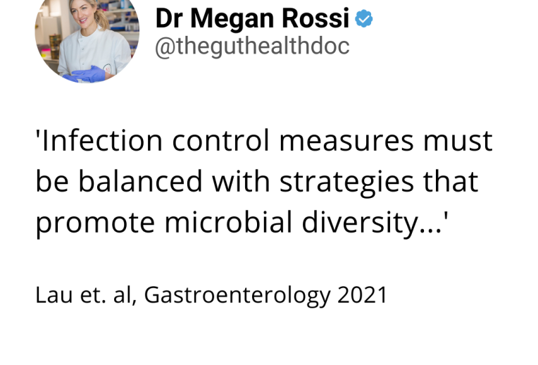 Dr Megan Rossi in a lab looking through a microscope