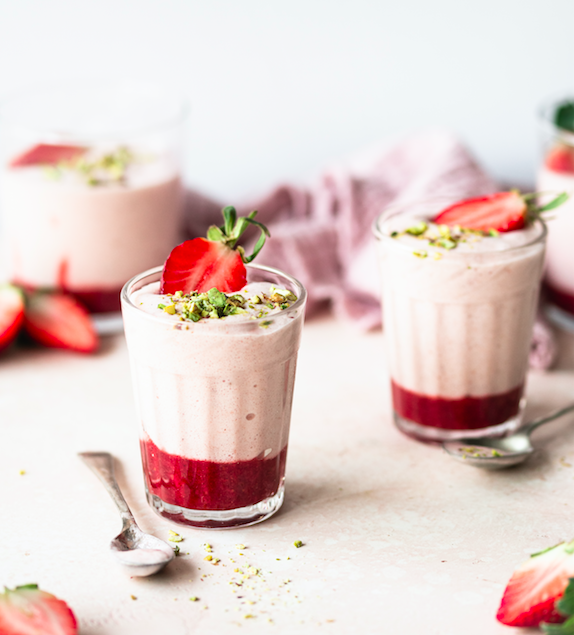 Three pots prebiotic strawberry mousse, topped with fresh strawberries