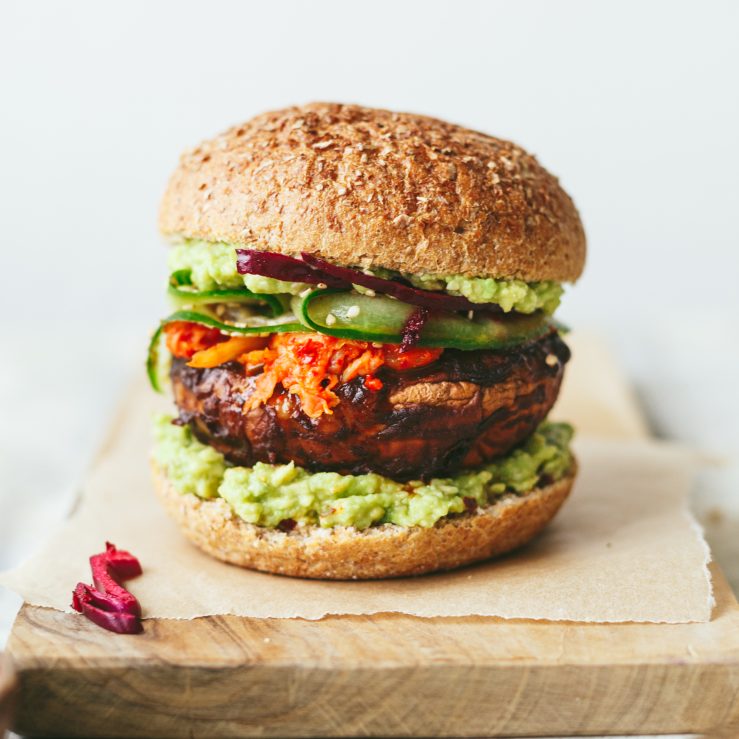 A wooden board with a spicy miso mushroom burger