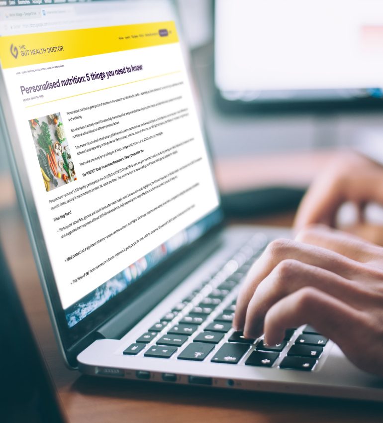 Person writing a blog post on a laptop