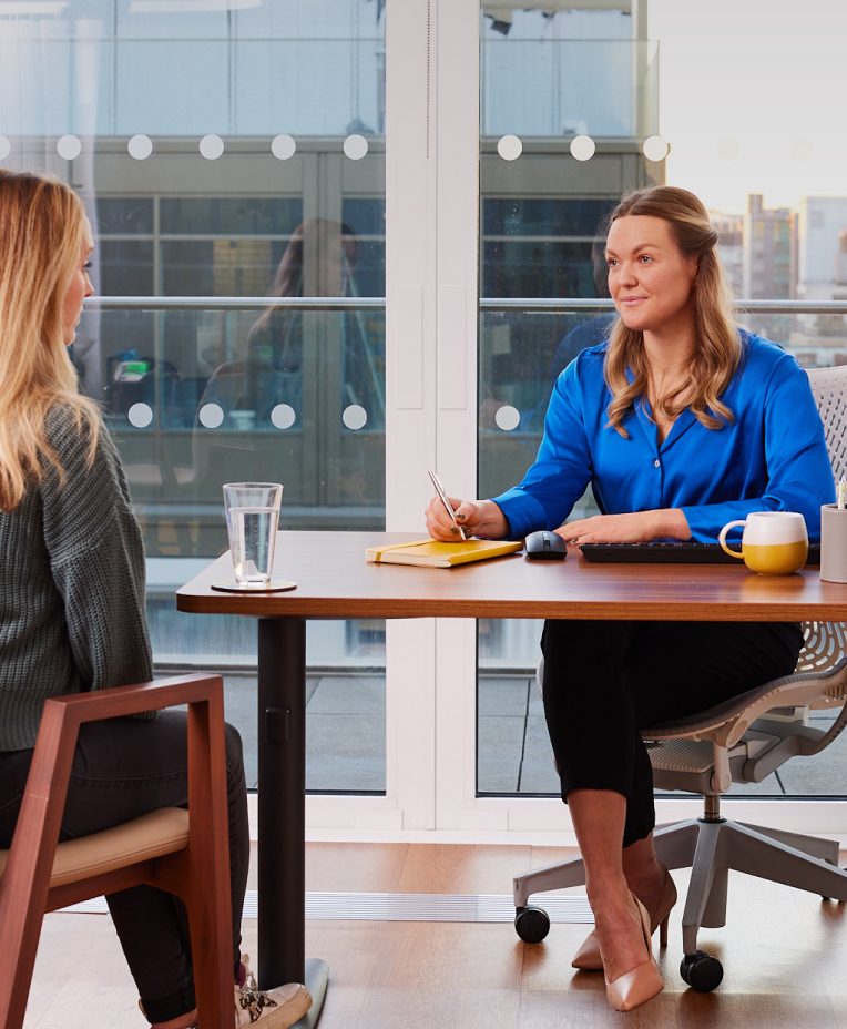 Two people in consultation across a desk