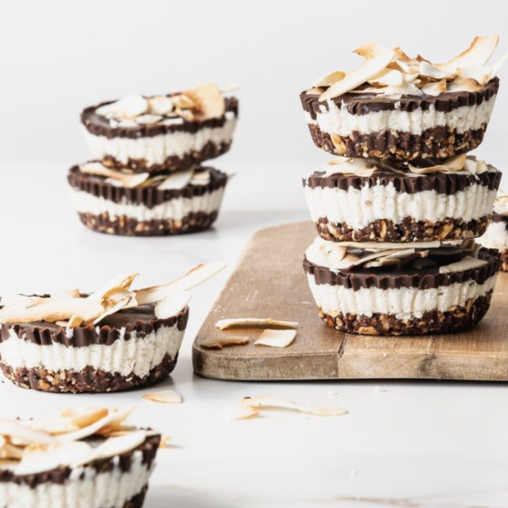 Three granola bounty bites stacked on a chopping board