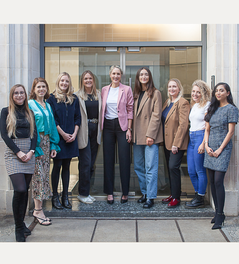 The gut health clinic team stood in front of glass doors