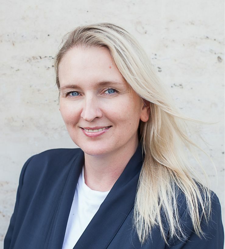 Image of a woman with blonde hair smiling