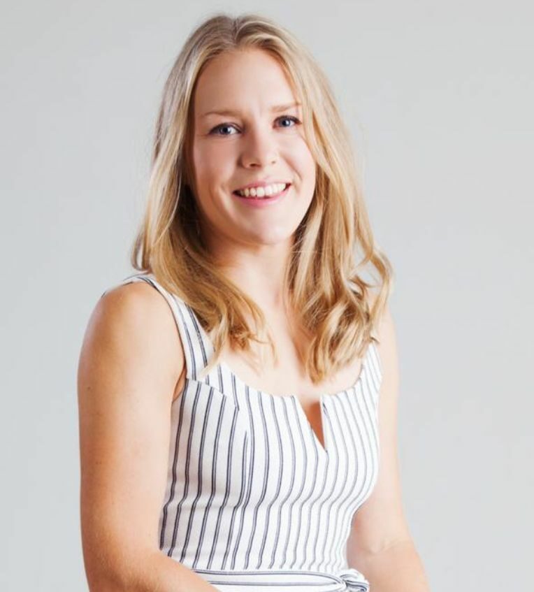 A photo of Emily, who has blonde hair, smiling