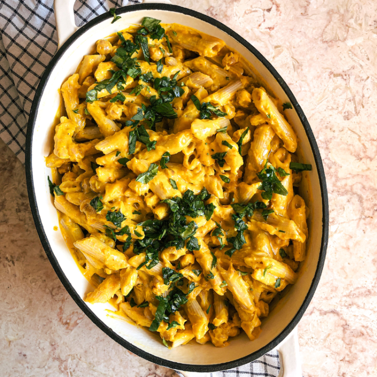 Photo of a casserole dish on a kitchen work surface with the dish sunshine pasta which includes herbs sprinkled on top