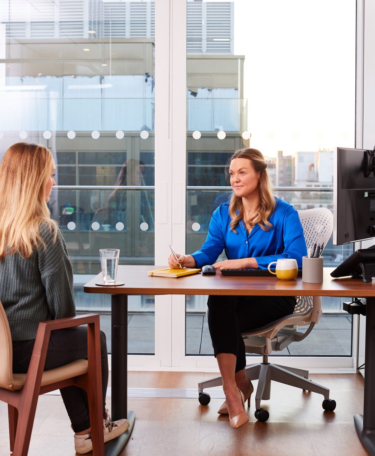 An image of a dietitian sitting across from a patient in an office