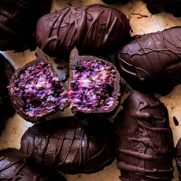 Photo of bitesize bounty bars that also include blueberries and beetroot, on a kitchen counter top