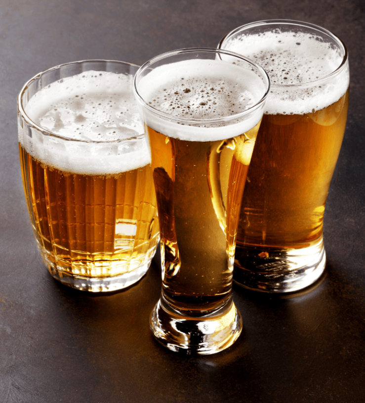 Three pints of lager on a table to demonstrate gluten in alcohol intolerance