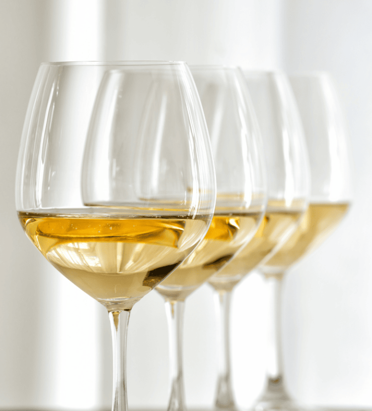 Three glasses of white wine on a table to demonstrate sulphite in alcohol intolerance