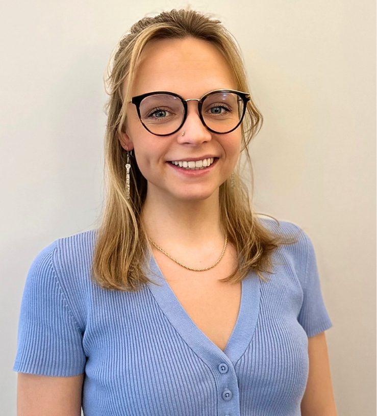 An image of Gabrielle Morse smiling, she has blonde hair and is wearing glasses