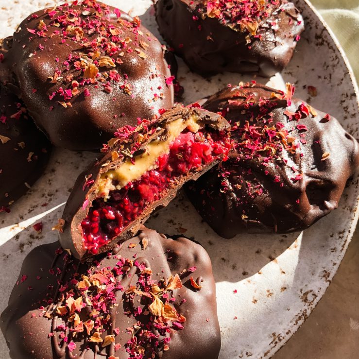 An image of the berry jam & nut butter chocolate bites on a plate